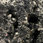 Load image into Gallery viewer, Close-up of a pyrite crystal with metallic and dark gray elements