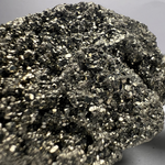 Load image into Gallery viewer, Close-up of a pyrite rock with a gray background